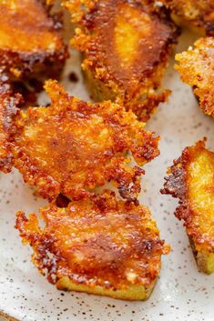 some fried food on a white plate with brown sugar sprinkled over it's edges