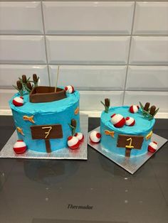 two cakes decorated to look like boats with numbers on them