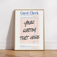 a poster with the words guest check on it in front of a white wall and wooden floor