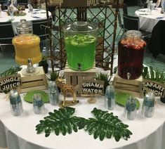 a table topped with lots of different types of drinks