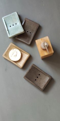 four different types of buttons are placed on a surface with one button facing the other