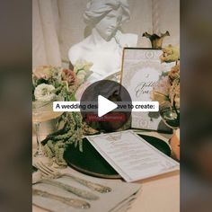 a table topped with plates and silverware next to a statue