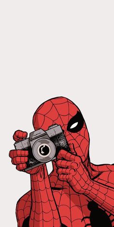 a spider man holding a camera up to his face