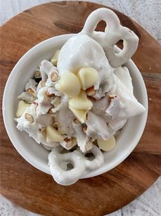 a white bowl filled with food on top of a wooden table