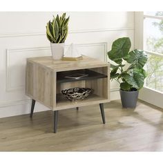 a wooden table with a potted plant next to it