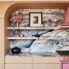 a pink stove top oven sitting inside of a kitchen