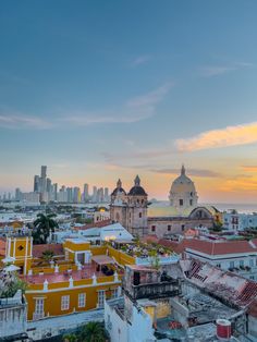 the city skyline is shown at sunset with tall buildings