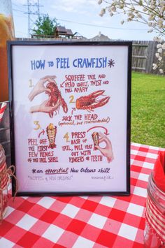 a sign on a table with instructions for how to peel crawfish in it