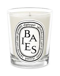 a glass candle with the words baes printed on it's front and side