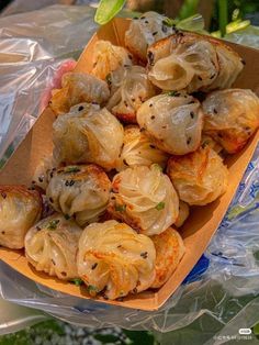 some food is sitting in a box on plastic wrapper and ready to be eaten