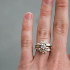 a woman's hand with two rings on it