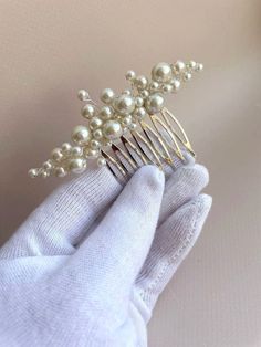 Welcome to our Etsy listing for a classic pearl hair comb designed specifically for the bride on her special day! This exquisite hair accessory is delicately crafted to add a touch of lightness and elegance to any wedding ensemble. Our pearl hair comb is meticulously handmade using premium quality materials, ensuring both durability and beauty that lasts a lifetime. The pearls are carefully selected to exude a timeless charm, complementing the bride's attire with grace and sophistication. Measuring at an ideal size of approximately 3 inches, this bridal hair comb is designed to effortlessly enhance any wedding hairstyle. Its universal appeal means it seamlessly integrates with various hairdos, offering versatility to brides with different preferences and styles. Whether you opt for a tradi Hair Jewelry Wedding Brides & Hairpins, Wedding Hair Jewelry Brides & Hairpins, All Down Wedding Hair Styling Accessories, Modern Wedding Accessories, Pearl Hair Pins Bride, Bridal Hair Accessories With Pearls, Minimalist Wedding Hair Jewelry, Hair Assesories For Bride, Pear Bridal Hair Piece