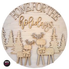 a wooden sign that says home for the holidays with two reindeers and one moose