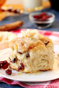 a close up of a plate of food with cranberry scones on it