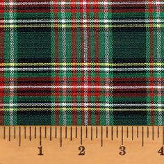 a green and red plaid fabric on a ruler