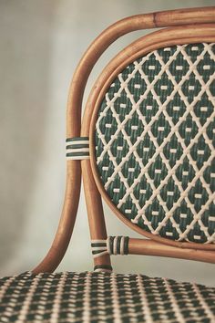 a close up of a chair with a green and white pattern on the backrest