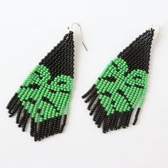 green and black seed beaded earrings with an image of the face of yoda