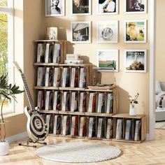 a living room filled with lots of dvd's next to a wall mounted on the wall