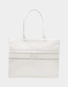 BRIDE TOTE WHITE Canvas Bag | Bridal Tote Bags – Betsey Johnson White Shoulder Bag For Wedding Gift, White Wedding Gift Bag, Chic Wedding Tote Shoulder Bag, White Tote Shoulder Bag For Wedding, Chic Tote Shoulder Bag For Wedding, White Canvas Bag With Dust Bag, Wedding Gift Bag Tote, Elegant White Canvas Bag With Double Handle, Chic White Wedding Bags