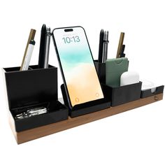 an iphone and pen holder on a wooden shelf