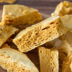 sliced pieces of bread sitting on top of a wooden cutting board