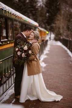 a bride and groom kissing in front of a trolley