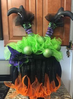 a kitchen counter topped with black and green decorations