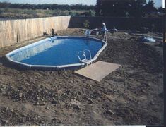 an above ground swimming pool in the middle of a yard with no cover on it