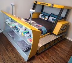 a child's bed made to look like a track car with stuffed animals on it