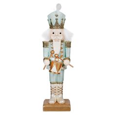 a nutcracker figurine wearing a blue suit and gold crown is shown