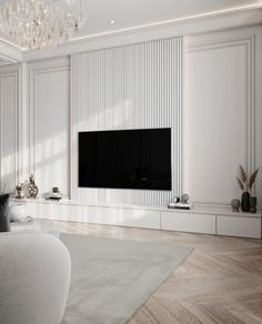 a living room with white furniture and a large flat screen tv mounted on the wall