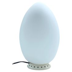 an egg shaped lamp on a white base