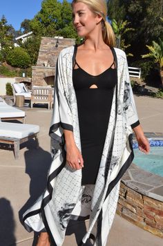 Enjoy summer in this beautiful silk white and black kimono. Dressy or casual . Not a sheer fabric. Medium weight silk. One size. The width is 52 inches when closed. The length is 50 inches. Elegant V-neck Kimono For Beach Cover-up, Summer Silk Kimono With Open Front, Silk Open Front Kimono For Summer, White V-neck Kimono For Day Out, Elegant Long Vacation Cover-up, Black Long Kimono For Beach Cover-up, White V-neck Kimono For Daywear, Long Silk Kimono For Beach, White Silk Kimono For Summer