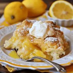 a close up of a plate of food with lemons and powdered sugar on it