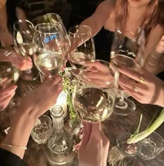 a group of people sitting at a table with wine glasses