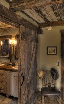 an open barn door leading to a bathroom