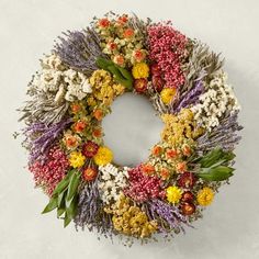 a wreath made out of dried flowers and leaves