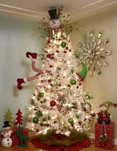 a white christmas tree with lights and decorations