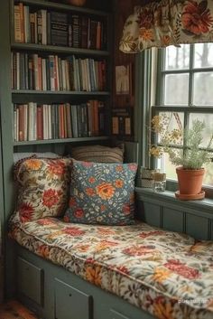 a window seat in front of a bookshelf filled with books