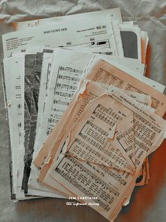 old sheet music sheets are piled on top of each other