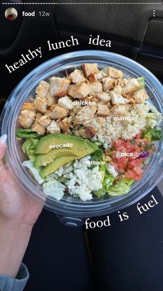 a person is holding a plastic bowl with food in it that includes chicken, rice and avocado