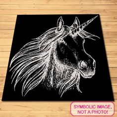 a black and white drawing of a unicorn's head on a wooden floor with the words symbolic image not a photo