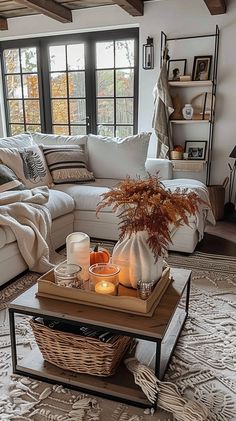 a living room filled with furniture and a fire place on top of a coffee table