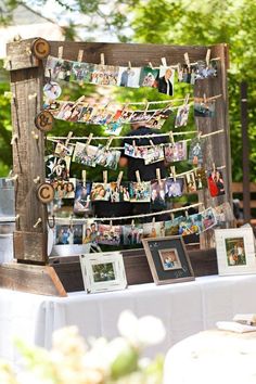 an old wooden frame with pictures hanging from it's sides and clothes pins attached to them