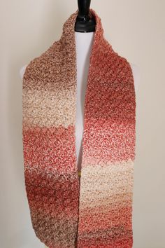 an orange and brown scarf on a mannequin