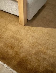 a close up of a bed with a wooden headboard and foot board on the floor