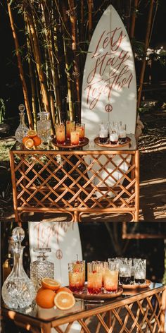 there is a surfboard and some drinks on the table