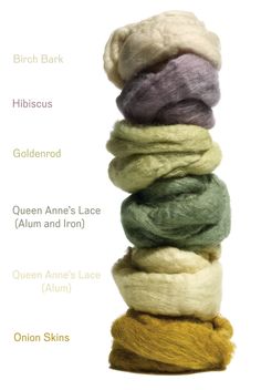 several skeins of wool are stacked on top of each other in different colors