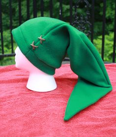 a green hat sitting on top of a white head