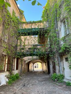 an old building with vines growing on it's walls and balconies above the doorway